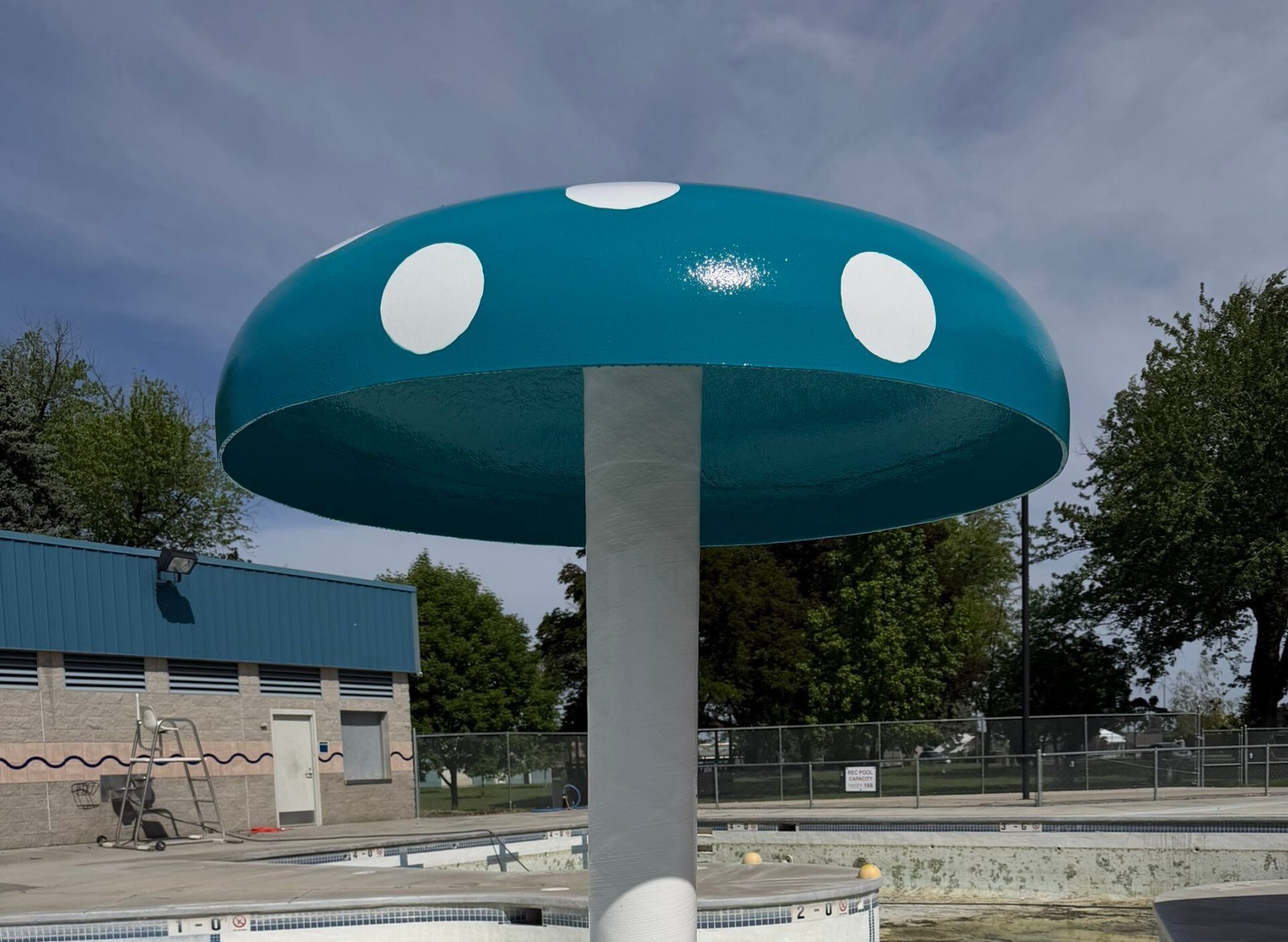 After restoration mushroom play feature with refreshed blue top and white polka dots at Ritzville Waterpark
