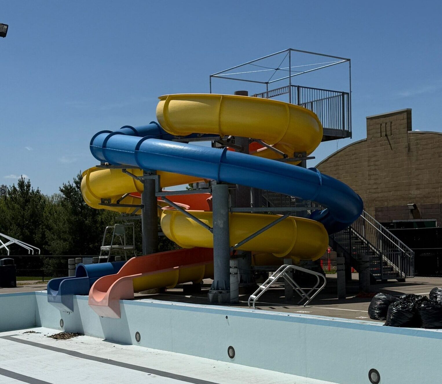 Yellow orange and blue waterslide complex at Pella Aquatic Center before restoration